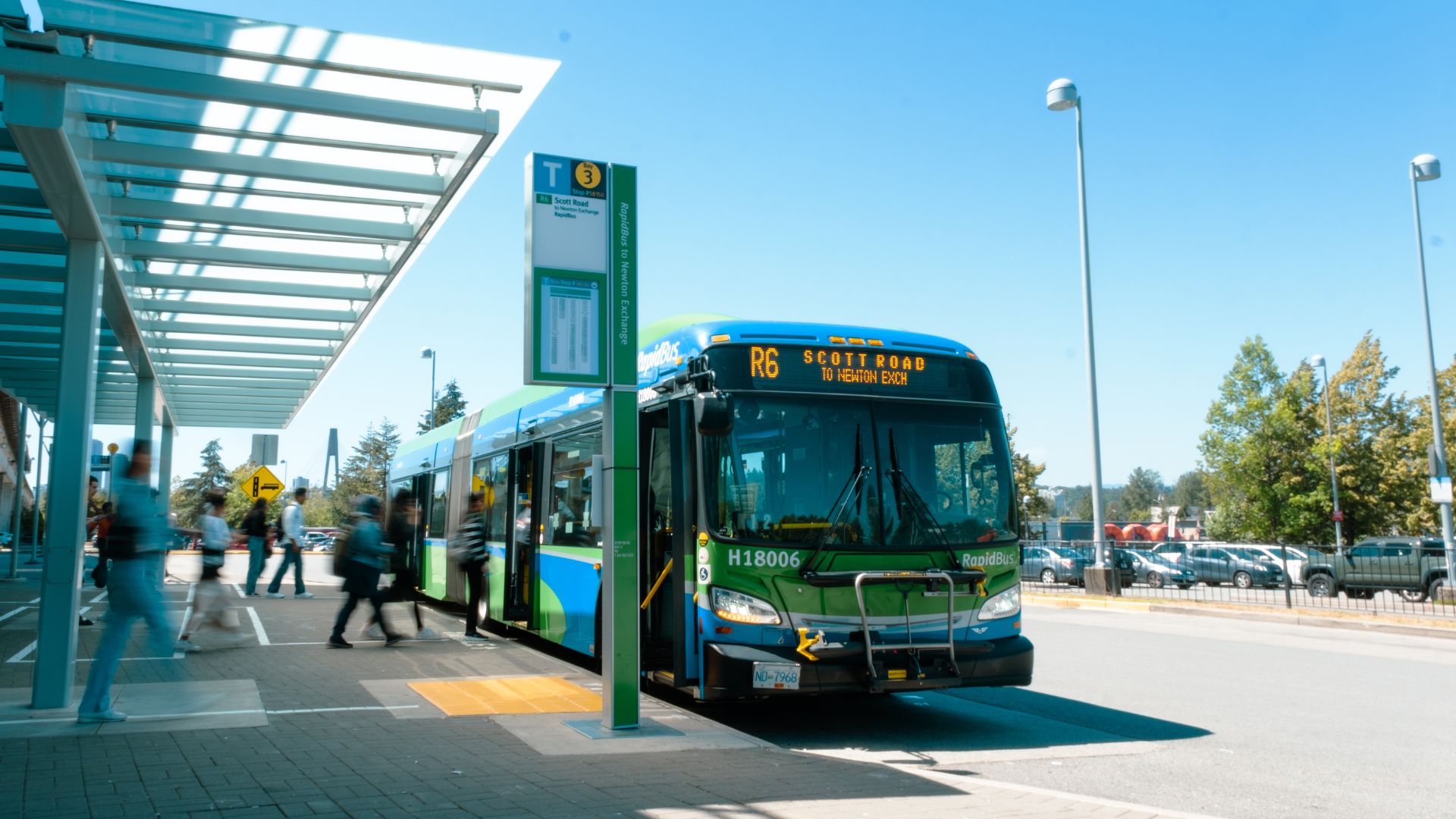 Coast Mountain Bus pulling up to a sheltered stop.