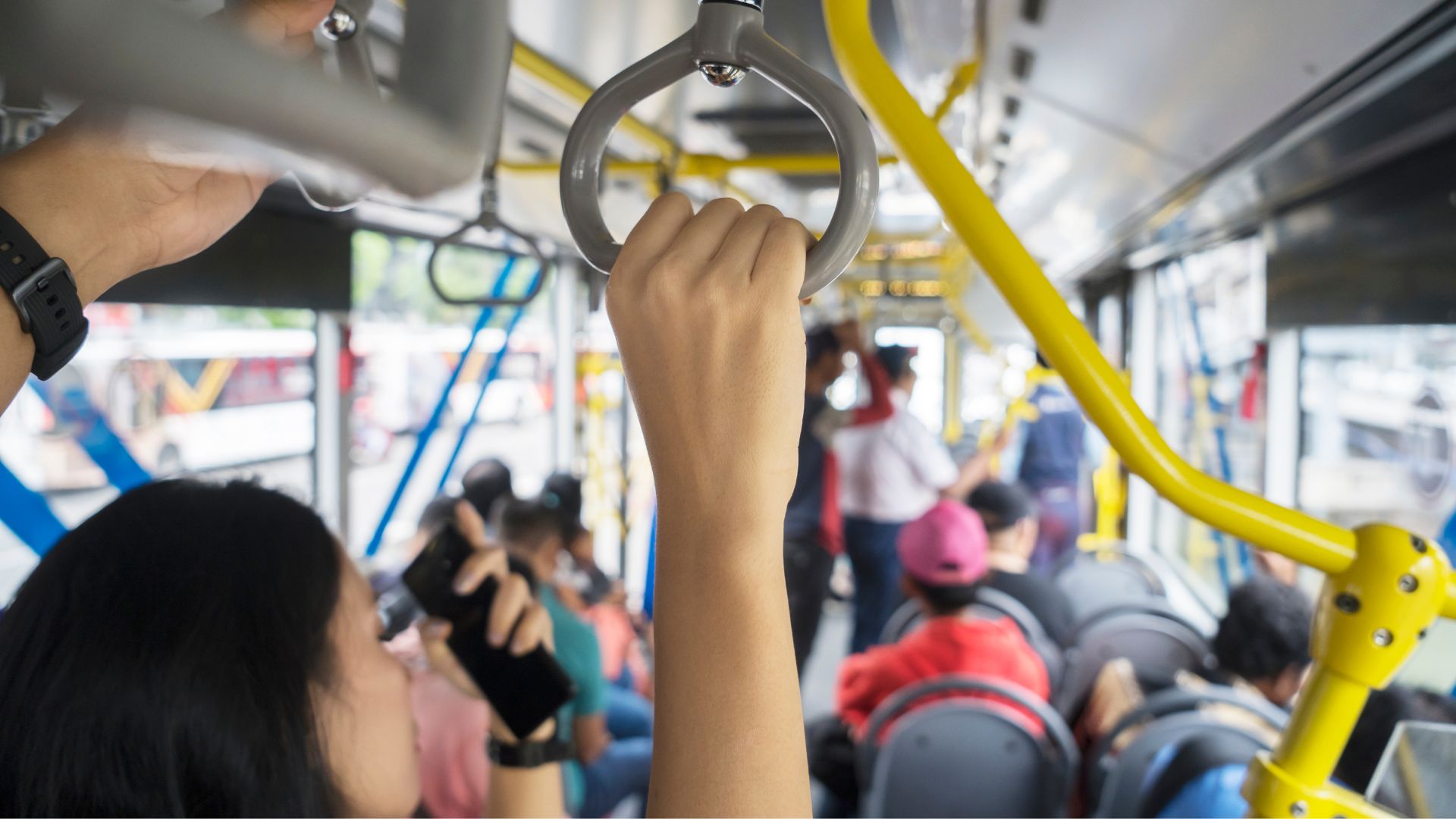 Crowd of riders onboard bus.