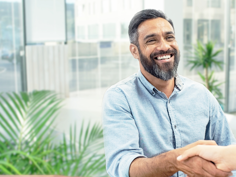 Smiling man shakes a hand